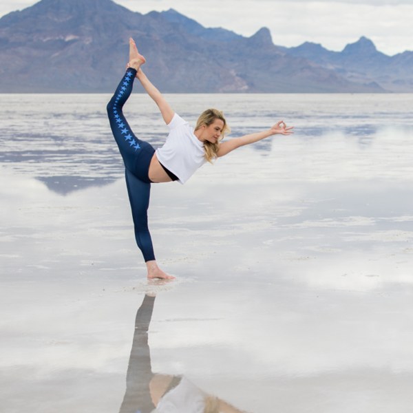 Jessica Bernstein, founder of U of Yoga, in Standing Bow Pulling Pose on the Bonneville Salt Flats