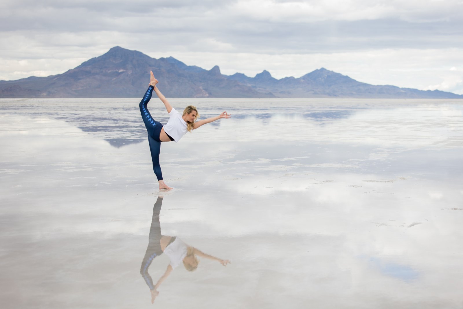 Jessica Bernstein, founder of U of Yoga, in Standing Bow Pulling Pose on the Bonneville Salt Flats, Utah